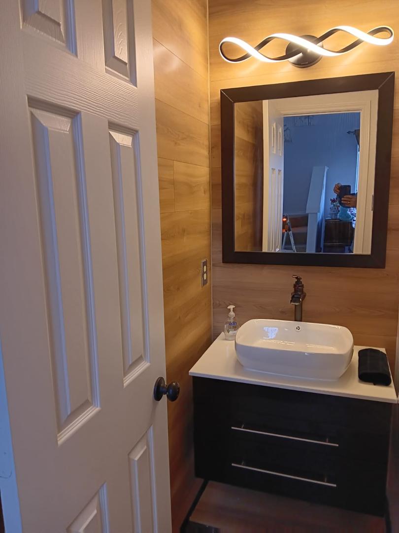 Completed bathroom lighting and mirror installation